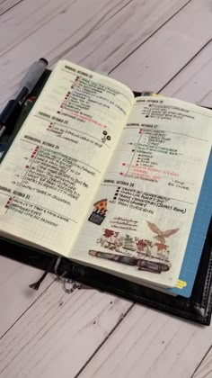 an open planner book sitting on top of a wooden table