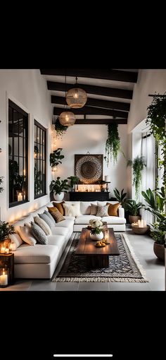 a living room filled with lots of furniture and plants