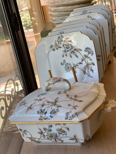 a stack of dishes sitting on top of each other in front of a glass door