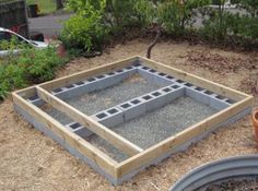 an outdoor area with concrete blocks and potted plants