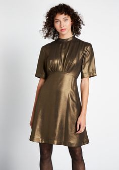 Make a grand entrance at the next soiree in this dark gold A-line dress. Easy to wear with boots or heels, this shimmery, short sleeve piece by Emily and Fin was made for fashionistas—just like you ! Shell: 100% Polyester. Lining: 100% Viscose. Machine wash. Side pockets. Fully lined. Back zipper with button closure. Imported Model is wearing size:S Fabric does not provide stretch. S=36 inches Length XXL=38.5 inches Length | Emily and Fin Shake and Shimmer A-Line Dress in Gold, Size 2XS Gold A Line Dress, A Line Dress Short, Vintage Style Swimwear, Sparkly Fashion, Casual Dresses Plus Size, Modern Vintage Style, Midi Dress Plus Size, Vintage Swimwear, Midi Dress Casual