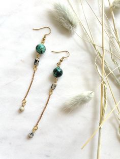 "These are long, beaded, dangle earrings featuring 10mm African Turquoise beads, brass chain, and rectangular Dalmatian Jasper beads. These unique boho earrings hang approximately 3.75\" inches from the lobe. The earwire is 18k gold plated and should be suitable if you have a metal allergy or sensitivity. These earrings are very lightweight and easy to wear. If you are not satisfied with your purchase, contact me within 14 days, and return your earrings in the original packaging for a full refun Turquoise Bohemian Earrings With Beaded Chain, Turquoise Beaded Chain Drop Earrings, Bohemian Drop Earrings With Adjustable Chain, Bohemian Style Long Drop Beaded Earrings, Adjustable Dangle Earrings With Beaded Chain, Adjustable Beaded Chain Dangle Earrings, Adjustable Beaded Chain Drop Earrings, Turquoise Earrings With Beaded Chain And Round Beads, Turquoise Earrings With Beaded Chain