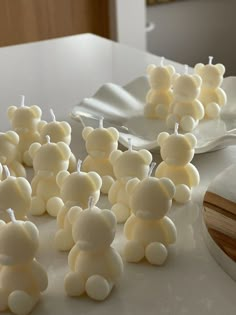 there are many small teddy bears made out of marshmallows on the table