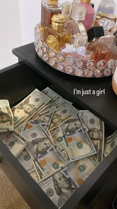 money is sitting on top of a table with perfume bottles and other items in the background