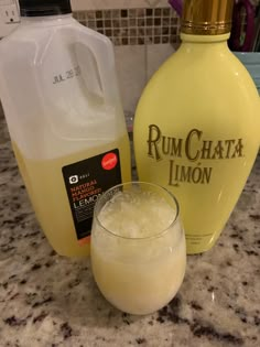 a bottle of rumchata limo next to a glass full of lemonade on a counter