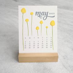 a desk calendar with yellow flowers on it