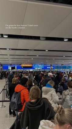 many people are waiting for their luggage at the airport