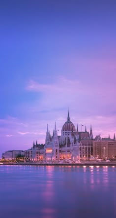 a large building sitting on the side of a body of water