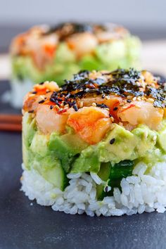 sushi with shrimp and avocado on top of rice