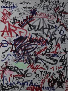 a large group of graffiti written on the wall