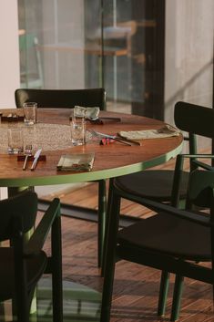 the table is set with empty glasses and utensils