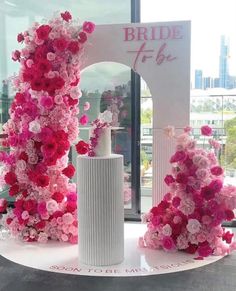 pink and white flowers on display in front of a window