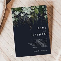 an elegant wedding card with greenery on the front and back is shown in black