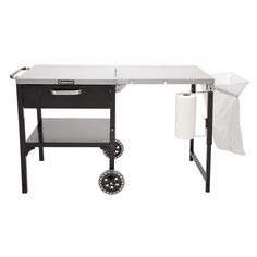 a black and white desk with a roll of toilet paper on the table next to it