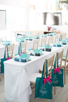 there are many chairs and tables set up with bags on the table to hold cupcakes