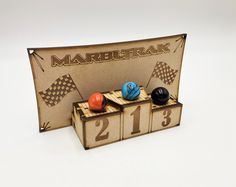 a wooden box with three balls in it and the number thirteen on each one side