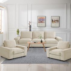 a living room with white walls and furniture in the corner, including two couches and one loveseat