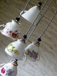 a group of tea cups hanging from a ceiling