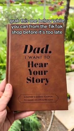 a person holding up a book with the words dad i want to hear your story