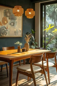 a dining room table with chairs and vases on it