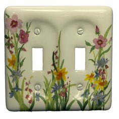 a white light switch cover with flowers painted on the front and back of each outlet