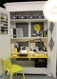 a yellow chair sitting in front of a computer desk