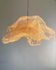 a light that is hanging from a wire with some fabric on it's side