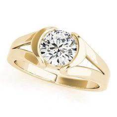 a yellow gold engagement ring with a round diamond in the center, on a white background