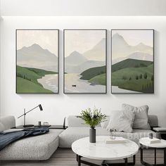 three paintings hang on the wall above a couch in a living room with a coffee table