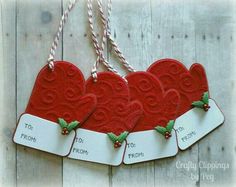 three red heart shaped tags with holly on them