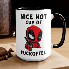 a coffee mug with the words nice hot cup of fuckofe on it next to a donut