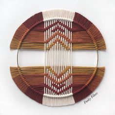 a piece of art that is made out of wood and yarn with different colors on it