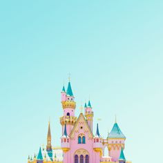 a pink castle with blue and yellow turrets