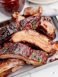 bbq ribs with barbecue sauce and garnishes on the side, ready to be eaten