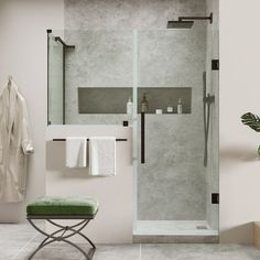 a walk in shower sitting next to a green bench and towel rack on the wall