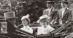 the queen and her family are riding in an open carriage with two men on either side