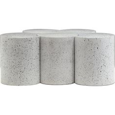 three white concrete stools sitting next to each other on top of a white floor