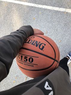 a person holding a basketball in their hand