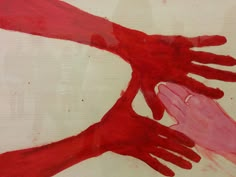 two red hands reaching for each other