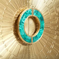 the inside of a decorative ceiling with blue and green glass in it's center