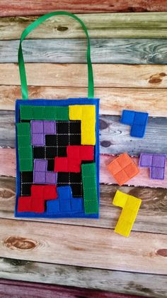 a bag made out of colored blocks sitting on top of a wooden table