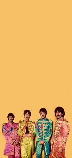 the beatles standing in front of an orange background