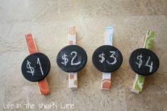 four black and white chalk markers with numbers on them, one for $ 1, two for $ 2, and the other for $ 3 for $ 4