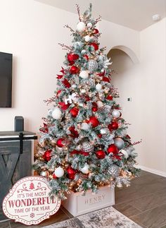 a decorated christmas tree with red and silver ornaments