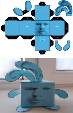 an image of the face of a man in front of a box with blue shapes on it