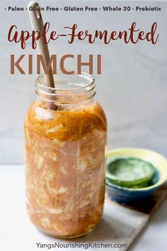 an apple - fermented kimchi in a mason jar with a spoon