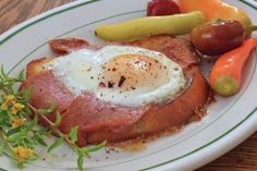 an egg is on top of some meat and vegetables