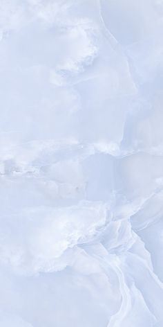 a man riding skis down the side of a snow covered slope on top of a snowboard