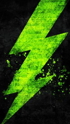 a green lightning bolt painted on the side of a black wall with paint splatters