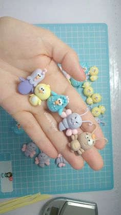 a person's hand with several small toy animals on it